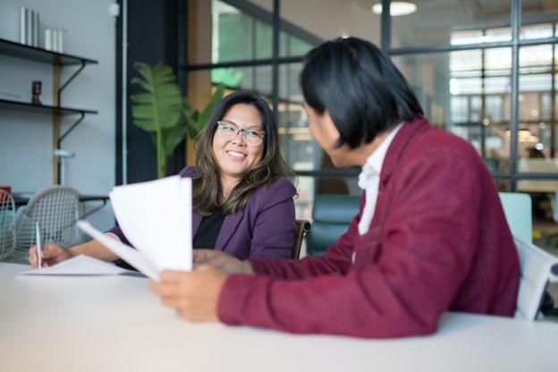 man and woman talking in conference room